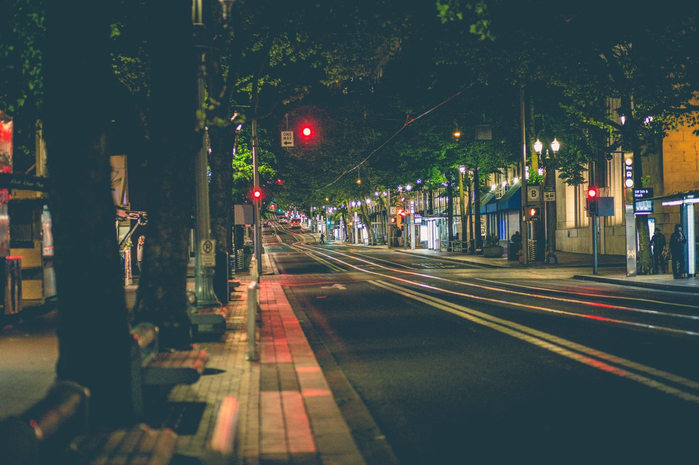 Downtown Portland, Oregon streetscape at night, grounding the firm in its home region